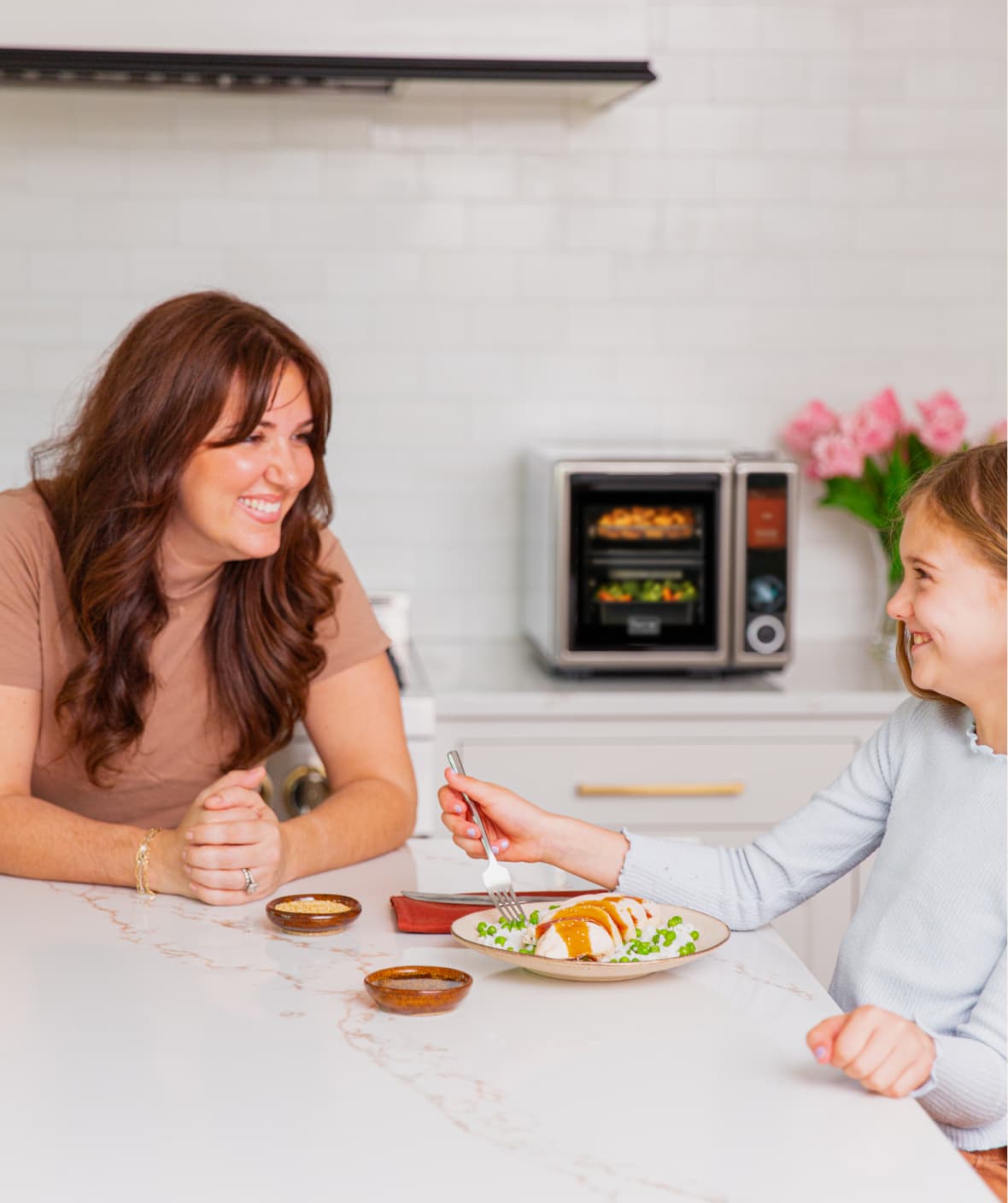Parent and child sharing a Suvie meal at the kitchen island